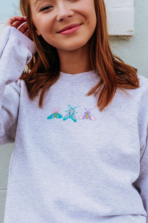 Embroidered trio of colourful moths sweater