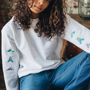 Embroidered trio of moths embroidered sleeve sweater