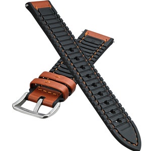 May include: A black and brown leather watch strap with orange stitching. The strap has a textured rubber design and a silver buckle.