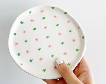 White porcelain ceramic dish with little pink flowers and green leaves