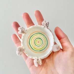 Hand built little white porcelain ceramic dish with colourful peach, lime, green ceramic porcelain dish with cream pom poms
