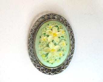 Vintage carved lucite floral oval brooch bezel set in silvertone mounting, 2" x 1 1/2". cream=yellow flowers on mint green. #2704