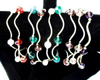 Set of 9 vntg stretch bead bracelets: beads & silvertone tubes, 3 lavender, 2 green 2 pearl, 1 red, 1 pink. Wearable. Estate sale find G095