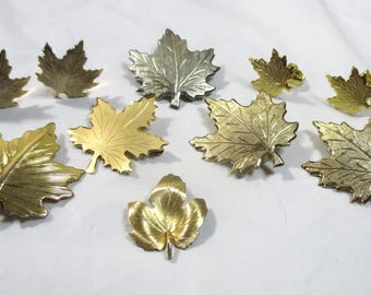 Lot Etched Gold & silver-toned maple leaf pins (6), clip back earrings (2 pr). 1 pin has Bond Boyd - Toronto mark. Estate Sale Items #2277