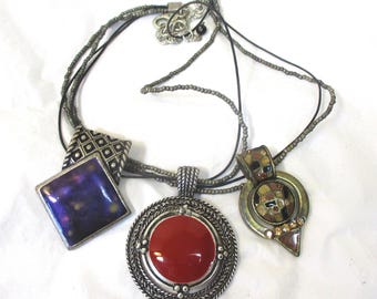 Chico's set: 3 metal pendants + 1 - 4 strand beaded/cord necklace. #2759