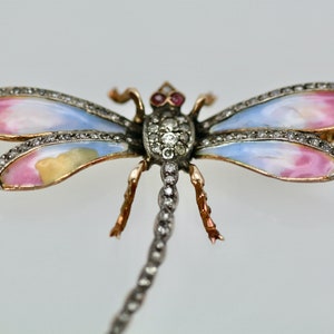 May include: A vintage dragonfly brooch with pink and blue enamel wings, set with diamonds and a ruby accent.