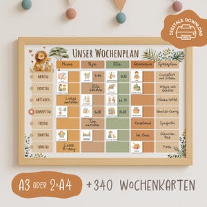 May include: A framed weekly planner with a light wood border. The planner features a neutral colour palette with illustrations and text in German. The text includes "UNSER WOCHENPLAN" and "DIGITALE DOWNLOAD". The planner is designed for family organisation.