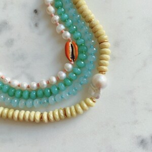 Freshwater pearl and cowrie necklace.