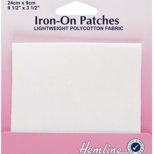 May include: A pack of white iron-on patches for mending or crafting. The pack is pink and says "Iron-On Patches" and "Lightweight Polycotton Fabric". The pack also says "Hemline" and "Quality Checked".