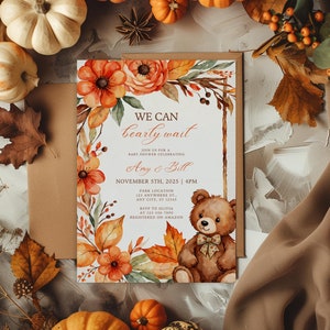 May include: A baby shower invitation with a watercolor illustration of fall leaves, flowers, and a teddy bear. The text reads "We can bearly wait" and includes the names "Amy & Bill", the date "November 5th, 2025", and the time "4PM".