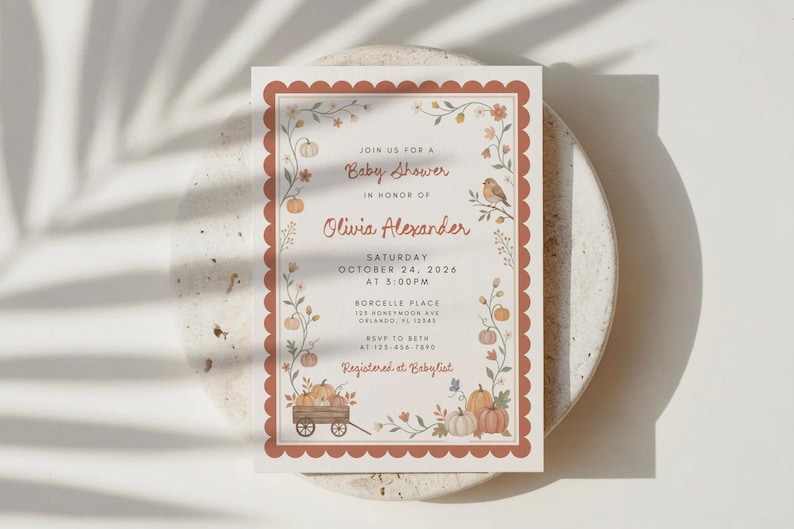 May include: A rectangular baby shower invitation card with a scalloped terracotta border. The design features watercolor illustrations of pumpkins, vines, and a small bird. Text includes: Join us for a Baby Shower in honor of Olivia Alexander, Saturday October 24, 2026 at 5:00PM, Borcelle Place 123 Honeymoon Ave Orlando, FL 12345, RSVP to Beth at 123-456-7890, Registered at Babylist.