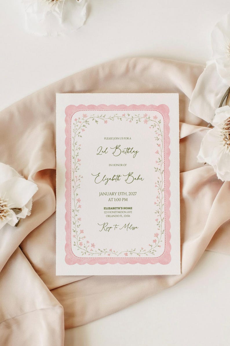 May include: A white invitation card with a pink scalloped border and floral accents. The text reads "2nd Birthday" and includes details for Elizabeth Baker's birthday on January 13th, 2027, at 1:00 PM, with an address and RSVP information.