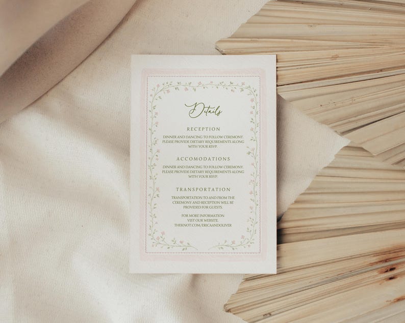 May include: A rectangular wedding details card with a pink border and floral accents. The card features the word "Details" in elegant script, followed by sections for reception, accommodations, and transportation information. The website address is also included.