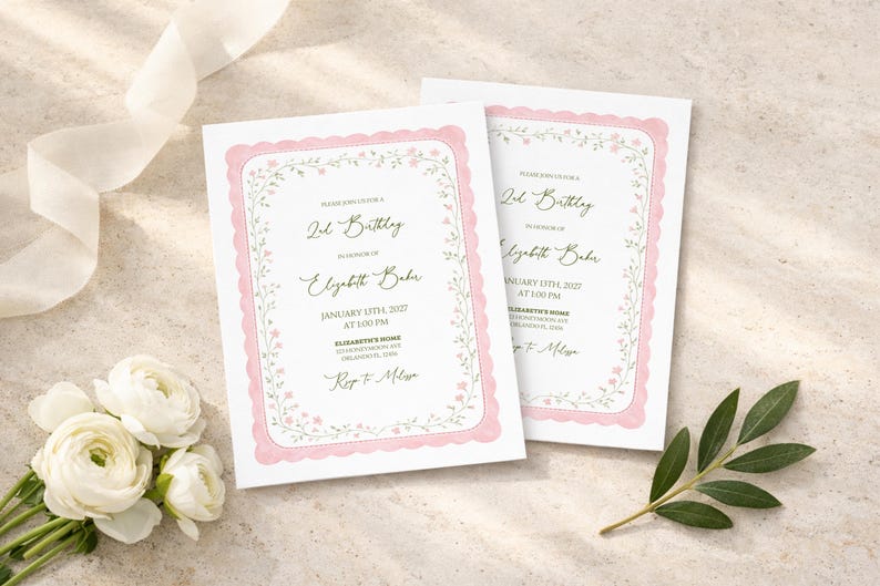 May include: Two birthday invitations with a pink scalloped border and floral accents. The text reads "2nd Birthday" and includes the name "Elizabeth Baker" and event details. White flowers and a ribbon are in the background.