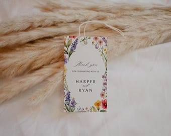 May include: A rectangular gift tag with a floral border featuring the text "Thank you for celebrating with us" and the names "Harper and Ryan". The tag has a white background and a string for attaching.