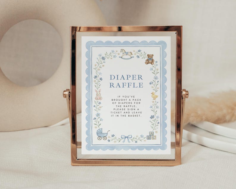 May include: A rectangular rose gold metal frame holding a white sign with a scalloped light blue border. The sign features floral illustrations, a rocking horse, a teddy bear, a rabbit, a duck, a stroller, and blocks with the text DIAPER RAFFLE.