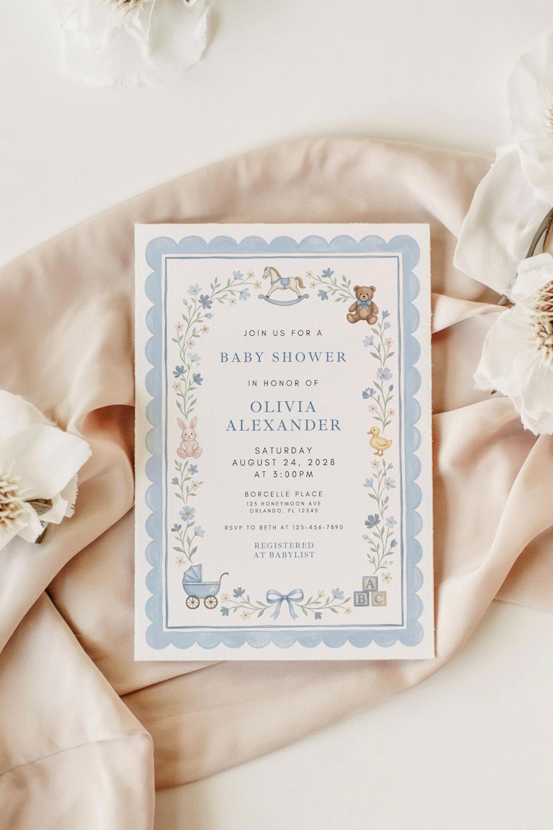 May include: Baby shower invitation with a blue scalloped border and floral accents. The invitation includes the text "Join us for a Baby Shower" and details for Olivia Alexander's baby shower, including the date, time, and location.