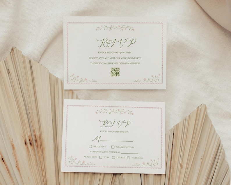 May include: Two RSVP cards with floral accents and a pink border. The cards feature the word "RSVP" in elegant script, along with instructions to respond by June 15th. The cards also include a QR code and a website address.