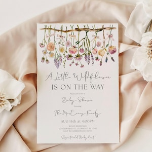 May include: A baby shower invitation with floral illustrations. The invitation reads "A Little Wildflower Is On The Way" in elegant script. The design features hanging flowers and the event details.