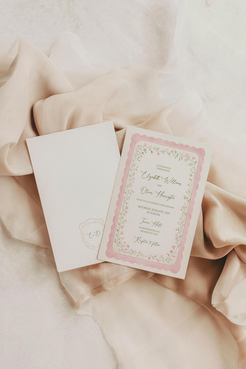 May include: Wedding invitation with a floral border and pink accents. The invitation includes the names Elizabeth Williams and Oliver Harrington, along with the date and time of the event. An envelope with a matching design is also present.