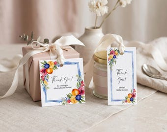 May include: Gift tags with watercolor floral and fruit designs. The tags say "Thank You!" and are for Olivia's Bridal Shower. A wrapped gift and a jar with a lid are also in the image.
