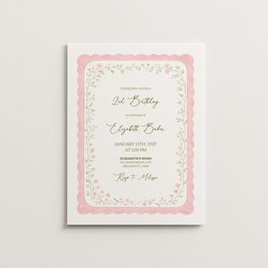 May include: A rectangular invitation card with a pink scalloped border and floral accents. The text reads "Please join us for a 2nd Birthday in honor of Elizabeth Baker" with date and address details. The card is on a white background.