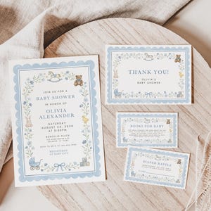 May include: A baby shower invitation suite with a light blue scalloped border. The invitation and accompanying cards feature illustrations of a rocking horse, teddy bear, and baby carriage. The text reads "Join us for a Baby Shower" and "Thank You!"