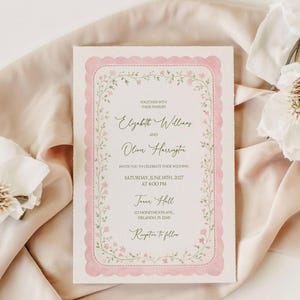 May include: A wedding invitation with a pink scalloped border and floral accents. The text reads "Elizabeth Williams and Oliver Harrington invite you to celebrate their wedding" on June 14th, 2027, at 4:00 PM, at Jane Hall in Orlando, FL.