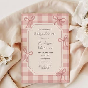 May include: A pink gingham baby shower invitation with bow accents. The invitation includes the text "Baby Shower" and details for Melissa Oliveria's shower on January 13th, 2026, at 1:00 PM. Registered at Babylist.