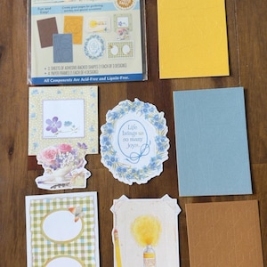 May include: A Hallmark Frames and Shapes Nature's Sketchbook set containing a package of adhesive-backed shapes and paper frames, along with several loose decorative paper frames and sheets featuring floral, butterfly, and art supply illustrations.