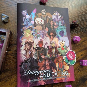 May include: A colourful zine titled "Dungeons and Dating: A Dungeons and Dragons Dating Show Zine" featuring illustrations of fantasy characters. A pink sticker with the text "Let's Date!" is on the cover.