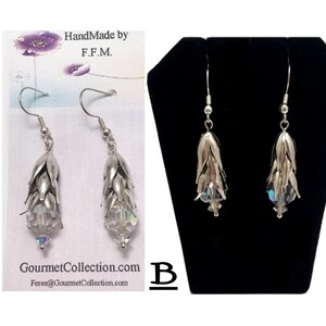 May include: A pair of silver dangle earrings with crystal accents. The earrings are shaped like a cluster of small bells. The earrings are handmade by F.F.M. and are available for purchase at GourmetCollection.com.