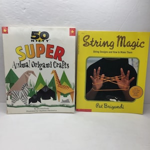 May include: Two books, one titled "50 Nifty Super Animal Origami Crafts" with a colorful illustration of origami animals, and the other titled "String Magic: String Designs and How to Make Them" with a photo of a person's hands making a string design.