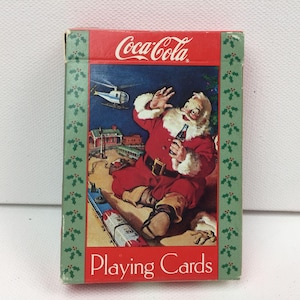 Baraja de cartas navideñas vintage de Coca-Cola con temática de Papá Noel y tren, de 1992