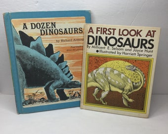 May include: Two vintage children's books about dinosaurs. The book on the left is titled "A Dozen Dinosaurs" by Richard Armour, illustrated by Paul Galdon. The book on the right is titled "A First Look at Dinosaurs" by Millicent E. Selsam and Joyce Hunt, illustrated by Harriett Springer.