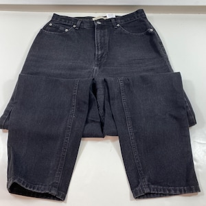 Puede incluir: Vaqueros negros de cintura alta con pierna recta. Los vaqueros tienen un diseño clásico de cinco bolsillos y cierre de botón.