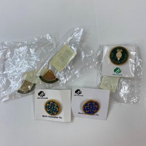 May include: A set of three ceramic nesting bowls in shades of blue, green, and white. The bowls feature a speckled glaze and a simple, modern design. The largest bowl is approximately 6 inches in diameter.