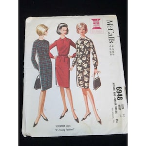 May include: Vintage McCall's sewing pattern for a misses' and junior dress. The pattern is for size 10, bust 31 inches. The pattern shows three women wearing different versions of the dress: one in plaid, one in red, and one in floral print. The pattern is titled "6948" and says "It's Young Fashion!"
