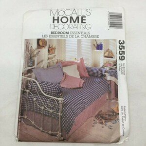 May include: McCall's Home Decorating sewing pattern for a daybed with a gingham patterned bedspread and pillows. The pattern number is 3559.