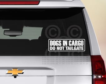 May include: A white car window sticker with black text that reads "Dogs in Cargo Do Not Tailgate".