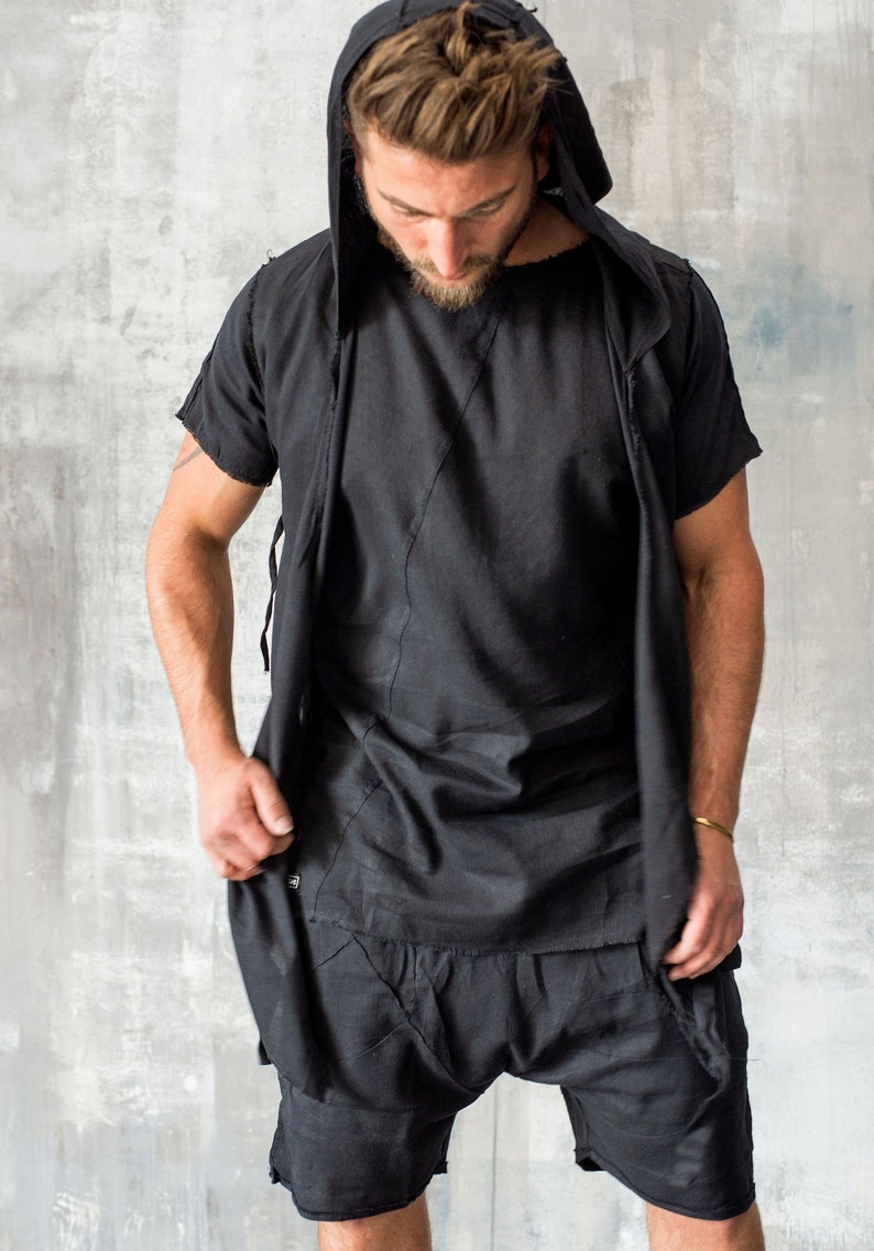 Puede incluir: Conjunto negro de camiseta con capucha y pantalones cortos. La camiseta de manga corta tiene un dise&ntilde;o cosido &uacute;nico, y los pantalones cortos tienen un estilo de tiro bajo. El conjunto est&aacute; hecho de tela ligera.