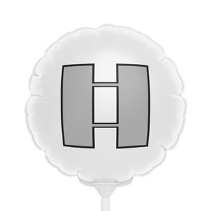 May include: A white, round balloon with a gray and black graphic design. The design features a gray shape with a black outline and two rectangular gray shapes. The balloon is attached to a white stick.