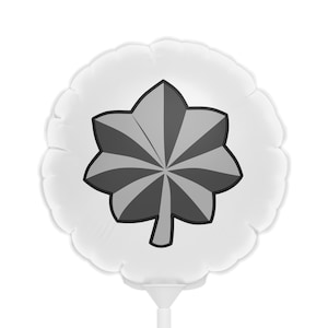May include: A white balloon with a gray five-pointed star printed on it. The star has a stylized design with multiple points.