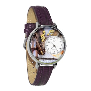 May include: A silver wristwatch with a purple leather band. The watch face features a violin, musical notes, and a sheet of music. The watch has a quartz movement and a white dial with black numerals.
