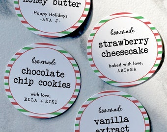 May include: Four round gift tags with red and green stripes. The tags have white text that reads "homemade cinnamon honey butter", "homemade chocolate chip cookies", "homemade strawberry cheesecake", and "homemade vanilla extract".