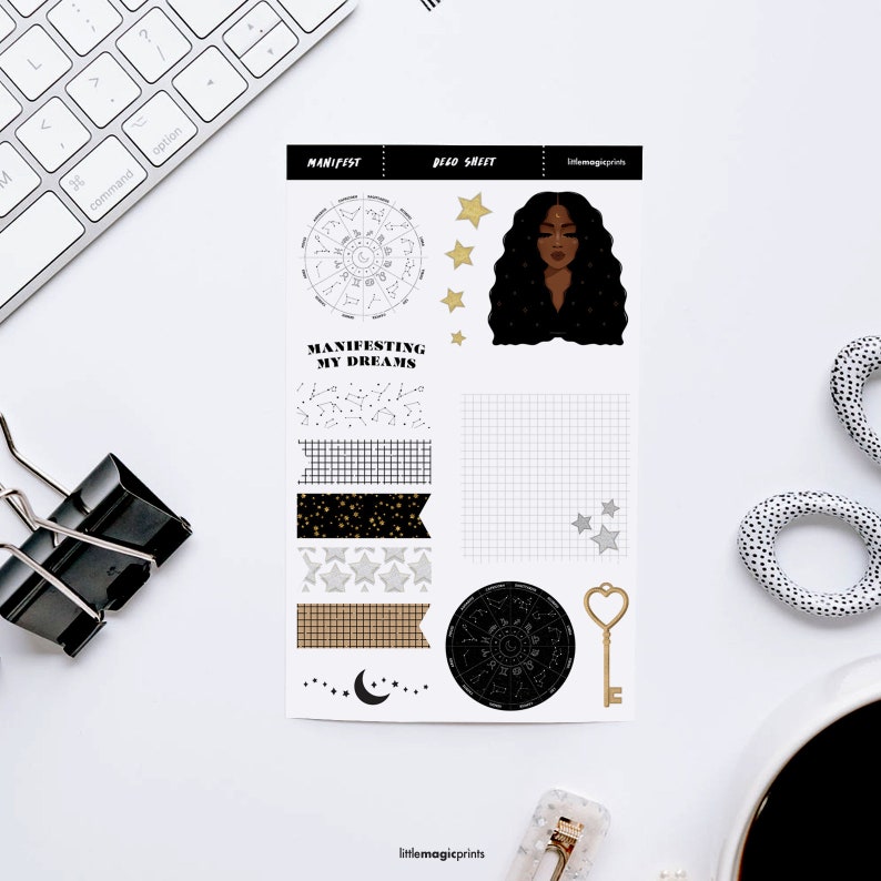May include: A printable sticker sheet with a celestial theme. The sheet includes a black and white zodiac wheel, a black and white grid, a black and white constellation pattern, a black and white moon, a gold key, and a black and white illustration of a woman with long black hair. The sheet also includes several decorative washi tape patterns with gold stars and black and white stars.