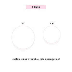 May include: White circles with pink outlines, one 2 inches in diameter and the other 1.5 inches in diameter, are displayed on a white background. The text "2 SIZES" is in a pink rectangle above the circles. The text "custom sizes available" is below.