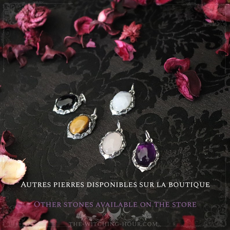 May include: Five silver pendants with different colored gemstones. The stones are black, tiger's eye, rose quartz, white, and amethyst. The pendants are on a black fabric background with dried rose petals. "AUTRES PIERRES DISPONIBLES SUR LA BOUTIQUE" and "OTHER STONES AVAILABLE ON THE STORE" are written in white text below the pendants. The website address "THE-WITCHING-HOUR.COM" is written in white text below the text.