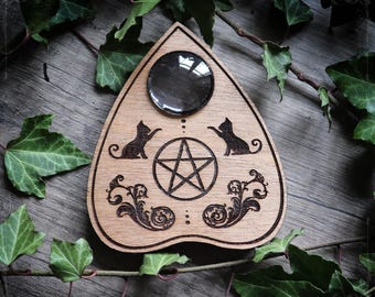 Wooden ouija planchette with cats and a pentagram, spiritualism tool or cabinet of curiosities decor