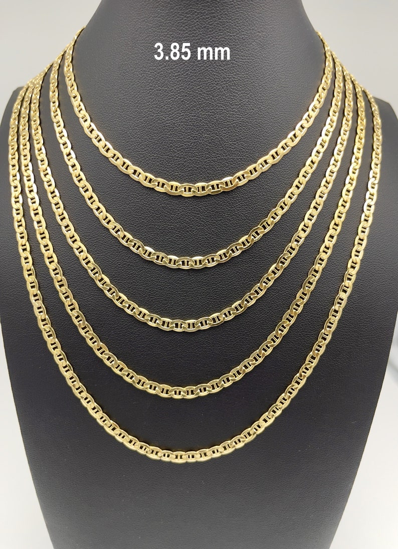 14k real yellow gold flat mariner link chain necklace. Sturdy 3.85mm yellow gold anchor link chain displayed in five sizes: 16 inch sits at the collarbone, 18 inch below the collarbone, 20 inch at upper chest, 22 inch at mid chest, and 24 inch longer layered style. Minimal 14k gold jewelry for men and women.